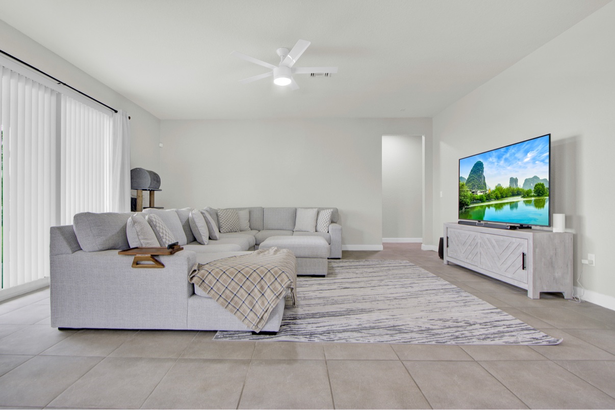 Renovated living room with large windows and light finishes