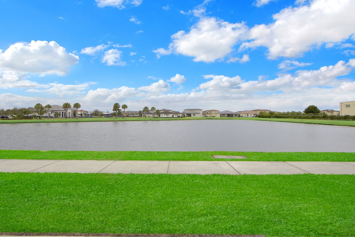 Community pond beneath blue skies